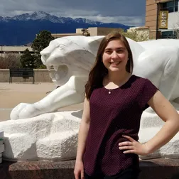 Picture of Women in front of Mountain Lion Statue